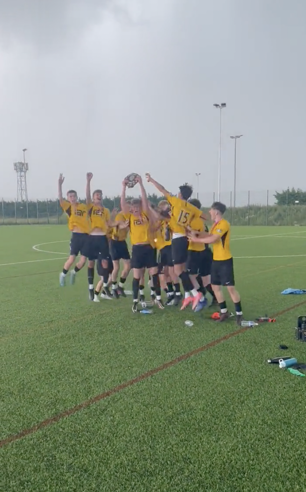 U16 football jumping to celebrate their winnings